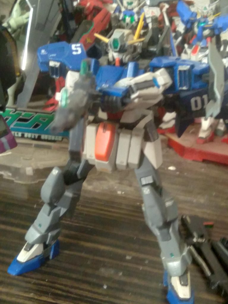 GN-R5 Gundam Lyra. The 5th Gundam of celestial being. This Gundam was completed in secret. Not even the Andromeda team knew of its existence. It has a gn rifle, gn sub machine gun, gn shield, and 2 gn beam sabers round out this gundams arsenal. Like it's brother unit, Antares, it has its own dedicated booster unit for improving mobility