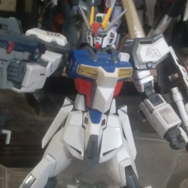 Hello Gunsta!! I wanted to show you what I have added to one of my Strike customs. I made the chest sensor from pla plate. I also had used putty and pla plate to reshape the torso. I love the way it looks now. It's beginning to look like a completely unique kit. I also added some chest vents from the lightning zeta. I attached some beam saber holders onto the back of the shield so now it can use them anytime. It also has the build Strike ankle armor. The rifle it uses is from the HGUC Tristan. There's some added connectors in the shoulders for mounting various equipment. It's almost time to start on the lower body. I haven't put much thought into it. I will need to look at some strikes here on gunsta and get some inspiration haha（1枚目）