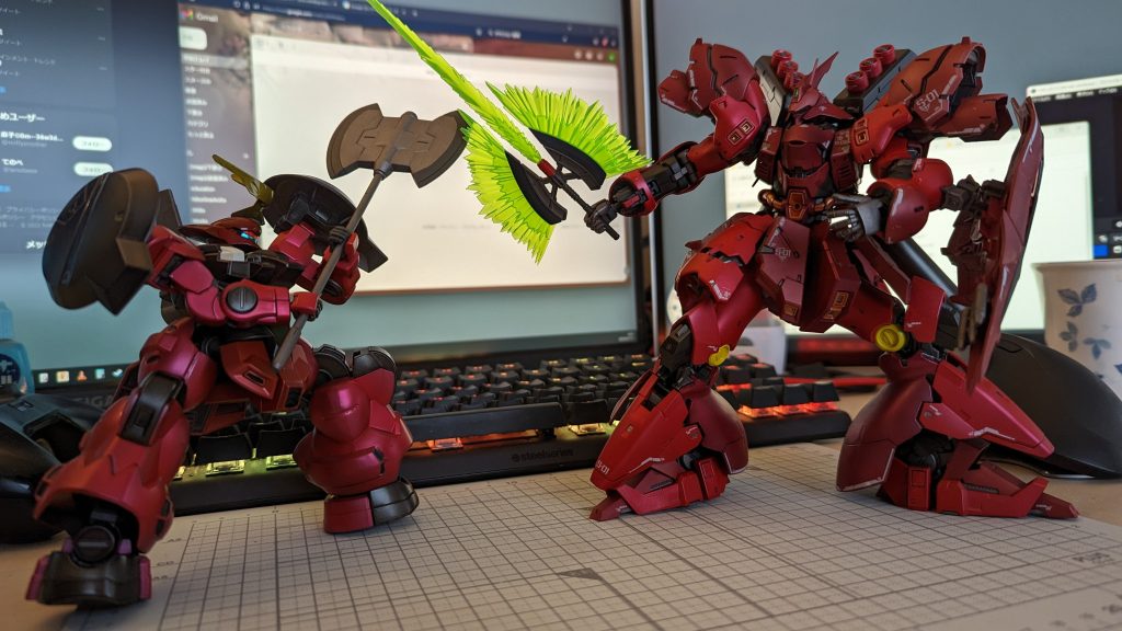 今回のサザビーを作る前の習作としてディランザ(水星の魔女)を赤く塗装してみたのですが、こちらのほうがいわゆる「キャンディ塗装」という方になると思います。銀色の下地(反射層)を作ってからカラークリアで色付け(カラーフィルタ層)するというのがキャンディ塗装の基本だと個人的には捉えてますが、ソレで作ったのがディランザの方です。なおディランザの方も表面はフラットクリアなので厳密にはキャンディとは言わないのかもしれませんが、そんな感じ。キャンディの場合、色調を基本的にカラークリアで整えないとアカンのが逆に調整幅が少ない気がしていて、下地が透けるパールで調整する最近のやり方は調整幅が広いんだなぁ…と思いました。