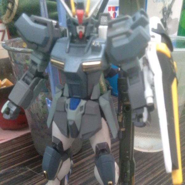 This is one of my Strike custom builds. It's meant to be a special ops Strike. A machine used on special missions that is able to get in under the radar and destroy any and all enemy mobile suits. I'm not quite done with the paint job. The backpack is from barbatos lupus rex that's been modified. The anti ship sword is from the perfect strike freedom and the agni is from the perfect strike. I have also added 2 beam saber handles to the shield. I transplanted the freedom knees to the strike legs using putty. Plastic plate was used to keep the backpack from moving around haha. I still need to find a beam rifle for it though. Let me know what you think of it!!（1枚目）