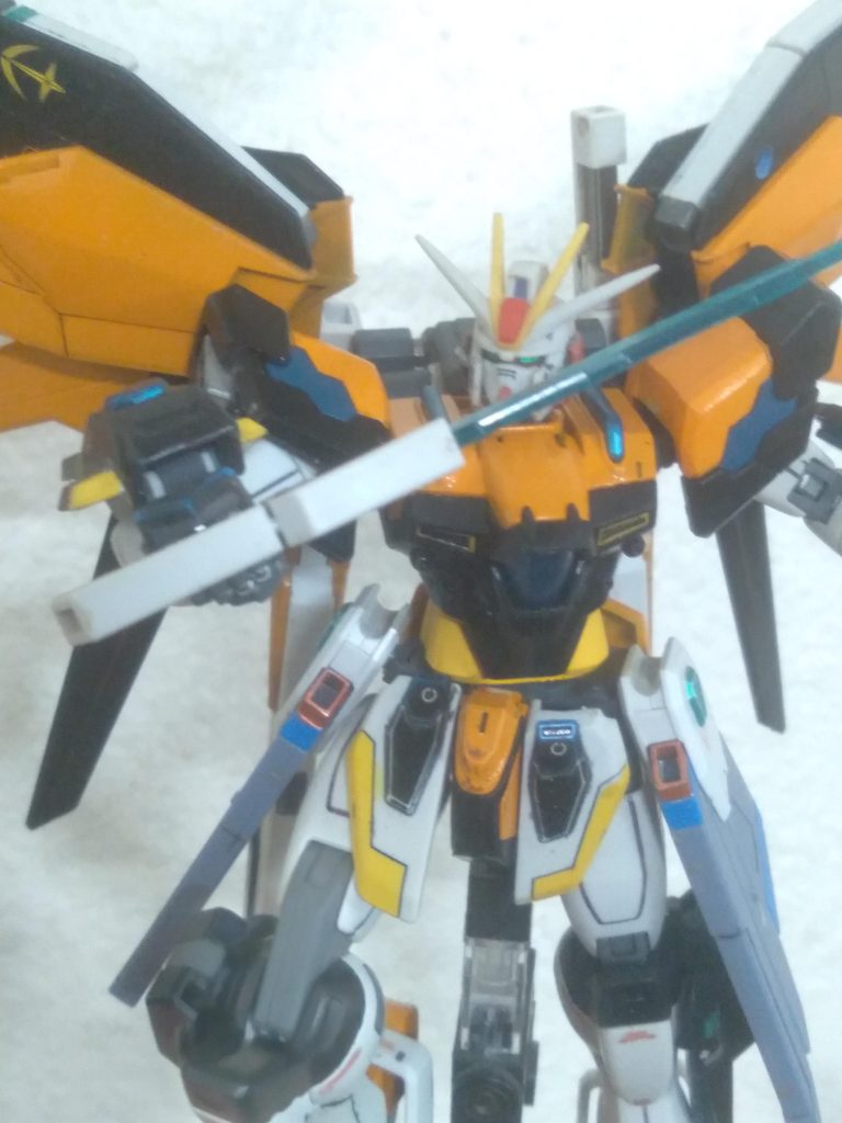 With the beam sword drawn. Due to having the freedom wings, the HiMAT mode is still available to be used for added mobility. The Helios Sol is a state of the art machine. Using an experimental dueterion battery, it can last much longer on the battlefield. If it happens to run low on energy, a satellite can locate it and fire a beam of energy to recharge the battery in no time