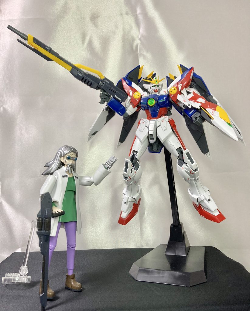 【XXXG-00W0 ウイングガンダムプロトゼロ】当時の独善的なOZにムカついて出奔した「プロフェッサーG」、「ドクトルS」、「H教授」、「老師O」、それとワシ「ドクターJ」の5人の技術者が開発していたガンダムじゃ。新型インターフェイス「ゼロシステム」・新規装甲材「ガンダニュウム合金」を用いたトールギスを遥かに上回るMSを目指していたが、パイロットへの過大な負担と機体の破壊係数の高さから危なかっしくて、実機を製造する事なく設計データを封印したんじゃよ。それ以降はワシら5人の技術者達は各々の拠点のコロニーに戻り、自身の得意とする技術を主としたガンダムを作っていく事になった。