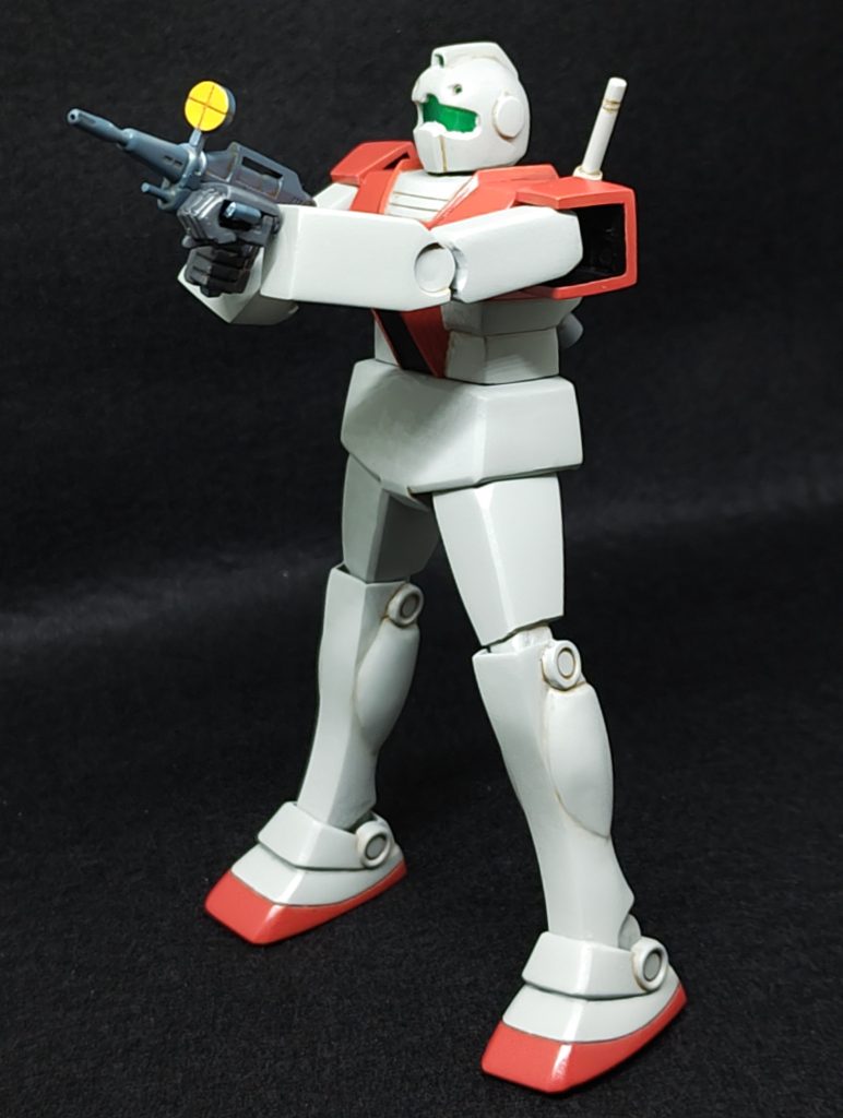 以前作った旧キットガンキャノン同様、旧キットのフォルムはそのままに、劇中のポーズを違和感バリバリに無理矢理再現するのがテーマです。上半身は幅詰めしていますが、これはプロポーションを修正するためではなく、両手でライフルを構えるのに、キットの胸幅では腕を前に伸ばせないからです。しかし上半身が小さくなったことで、腰ブロックがオムツの様に大きく見えるため、腹を2ミリ延長することでバランスを取ってみました。胸幅を詰めても、ライフルを構えるにはまだ腕が短いので、二の腕をプラ板とプラ棒で長めに自作しました。すると今度は前腕の太さが強調されてしまうのですが、ここまで修正してしまうと、旧キットのフォルムのままというテーマから外れてしまうので、そのままにしています。