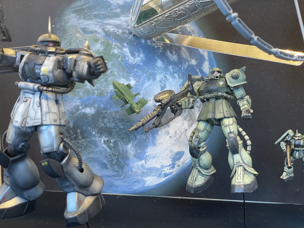 手間の銀色のパーソナルカラーのザクは旧HGUC、奥のザクはMS in action をリペイントした物と小さいザクは食玩をペイントした物です。スケールを変える事で遠近感を出してみました。奥のムサイはボトルキャップの物、頭上のコロニーはwaveのキットです。