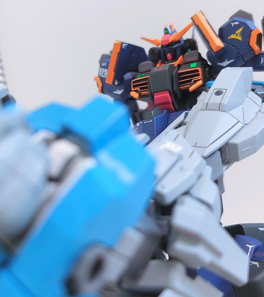 またこちらは、同じアナハイム製の試作機同士の貴重な戦闘記録である。キャロル·ヴィバリー中尉の駆るRX-90Tがビームライフルを持っていたであろう右腕部を切断され、とっさの反撃として脇腹に蹴りを入れた※3とされる写真。※3 帰還後、キャロル·ヴィバリー中尉は整備班にこっぴどく叱られた逸話がある。