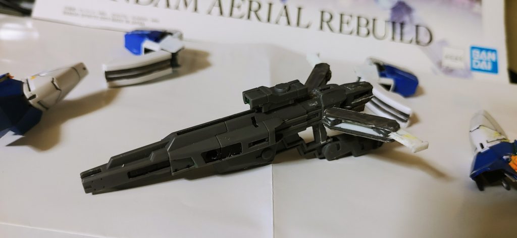 で、可変ユニットだけだと頭丸出し風味になるので、ビームライフルを改造。機首にしたときにロックがかかり、フェイスガードになるようにしました。さらに、ネオジム磁石2mm*1mmを数個駆使して、差し替えアームを差し替え無しで展開できるように改造。これに飽き足らず、より飛行形態がそれらしくなるように追加パーツを黙々と作りました。