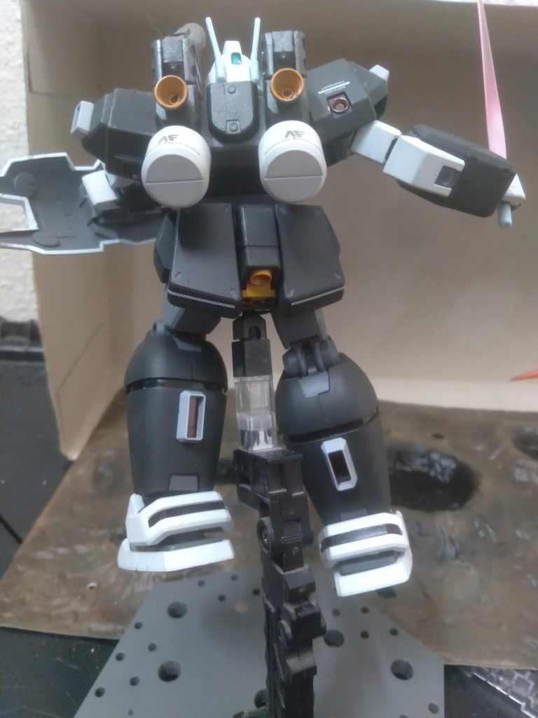 Behind. I used black to fill in the ankle armor section. I like how the orange inside the thrusters looks