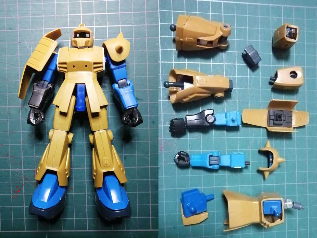 頭裏打ちして左右から削り込み 上を向かせる可動部を入れるため下面をくりぬいていますボディ同じく左右から削り込んで幅を狭くしています 肩をグフから移植していますが軸だけの移植だと強度に不安があるのでグフの基部ごと移植してプラバンでふさいでいます 股間もグフに旧キットをかぶせて接続軸もそのまま生かしています腕基本的に元の形状が似ているグフのままです ショルダーアーマーの取り付け部を左右で位置を調整しながら付け替えています シールドがペラペラなので裏面に装甲のパーツを付けています足膝の関節だけグフから移設して上下は幅詰めした旧キットです 足首のボールジョイントを移設して見えないようにディティールアップで隠しています 動力パイプはメッキされたプラスチックパーツを塗装して使っていますバックパック基本的キットのままで細かなディテールアップを追加 ビックガンアタッチメントのつけ外しは塗装が剝がれるためアーム可動させる仕組み導入で先が外れるようにしています スモーク弾の発射基部もポリパーツに変更しています