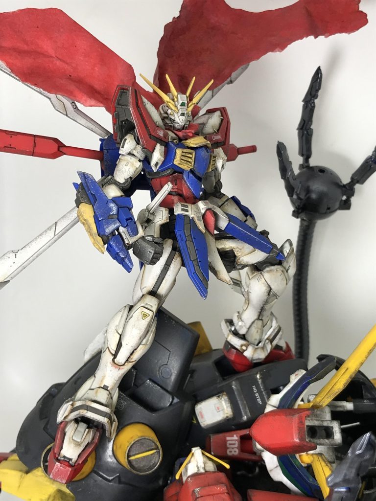 試作段階で最高にカッコよく撮れた一枚これはイケるぞ!とゴッドガンダムとマントに汚しと差し色を追加、デビルガンダムに破壊あとのケーブルを追加して…完成品を写真に撮るも…これ以上にカッコよく撮れた写真はなし…😭同じ構図で撮ったつもりでも、数ミリ単位の写角やポーズの違いで全然カッコ良さが引き出せないと痛感…😱