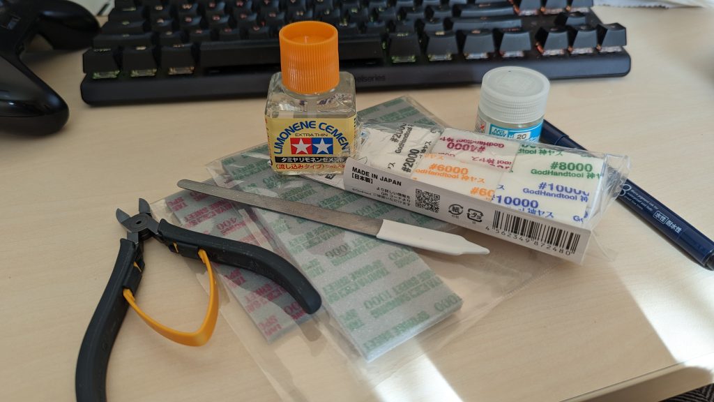 記憶装置を漁ってたら【当時に使ってた道具】の画像が出てきたのでコレも貼っときますが。・ニッパー・ヤスリ（金ヤスリとスポンジヤスリや使途が違います：重要）・接着剤（「パチ組み」が出来るようになったのは以後の製品のはず）・塗料（水性クリア、スミ入れ用のピグマ、塗布用の筆）ほんとに最初はコノぐらいで仕上げてました。