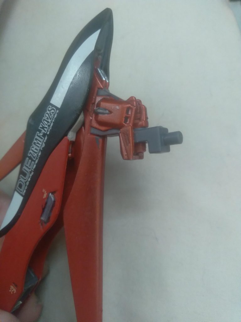 The part that piece comes off of is a 3mm peg. Use it to attach this part from the gunpla battle arms. You now can use the wings anywhere that has a 3mm hole