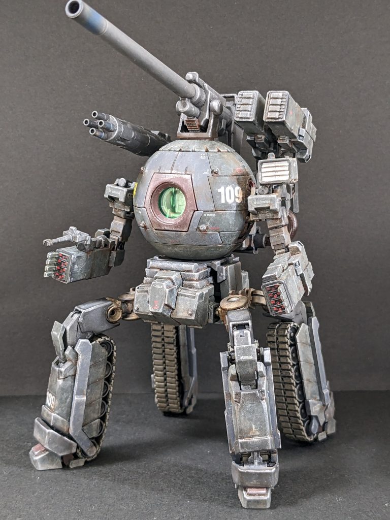 【正面】兵装は、遠距離:180mm低反動キャノン(頭頂部)・ミサイルコンテナ8門(左背部)、中~近距離:メガマシンキャノン(右背部)・マイクロミサイル24発(両腕部)、対人・対装甲車:25mmマシンキャノン(右腕部)。機動力・格闘能力はないので、運用は拠点攻略・防衛用か支援機になるでしょう。