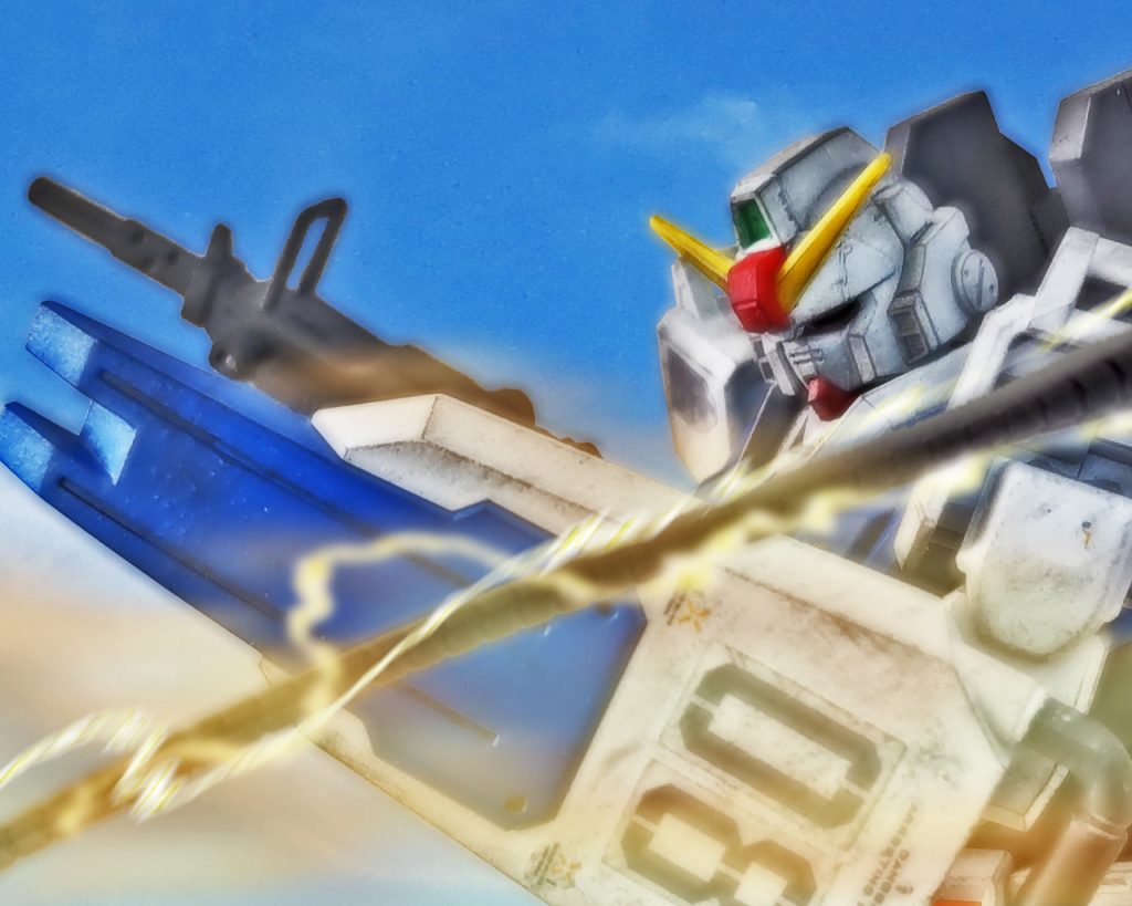 グフは腕を下から上に振り上げるように動かすとヒートロッドはそれに応えるようにしなる。それを陸戦型ガンダムはシールドでガード姿勢を取りながら避けるが一部のシステムに異常を検知するアラームが鳴った。グフはヒートロッドを一振りするとすれ違うように直ぐに離れたが、その間にシローは戦闘に支障がないのを確認する。シローはミケルが言った通りの戦い方をするグフにある戦法で挑むのを決めた。マシンガンを投げ捨てシールドもパージすると脚部からビームサーベルを2本抜き両手で構え格闘戦に打って出る。「隊長!なんのつもりです⁉」「無茶ですよぉ!正面からやり合うなんて?!」カレンとミケルの心配をよそにシローは言う。「もし俺の読みが正しければ間違いなくこの誘いに乗る。そしてヤツの弱点はその時に出る!」「どういう事です?」「カレンはビームライフルをスタンバイ。俺の後ろで何とか狙えるロングレンジの距離まで下がってくれ!」