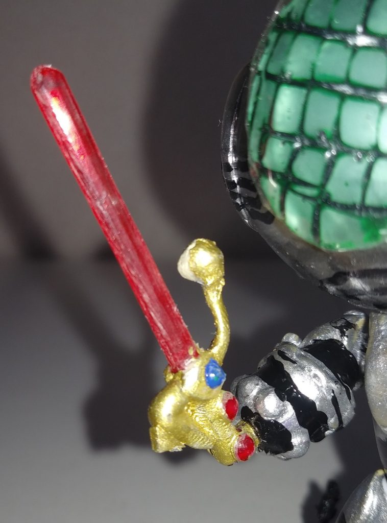 武器。「仮面ライダーBLACK」時のサタンサーベル。刀部分はクリアパーツのランナー。鞘は真鍮線。飾りは、１００均一のキラキラストーンシール(このシールは、シャドームーン本体にも使用)  