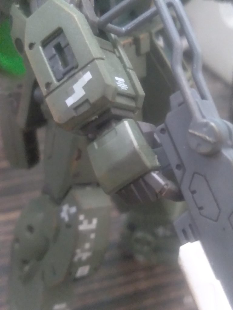 I really like the digital camouflage decals. For the weaponry, I didn't like the gatling gun that came in the box so I swapped it out to the 100MM machine gun from the ground gundam. 