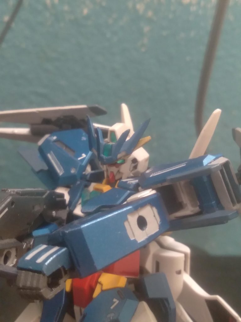 Added thrusters in the shoulders give even more control of the mobile suit. The sensor bits can function as beam amplifiers when arranged in front of the barrel of the rifle