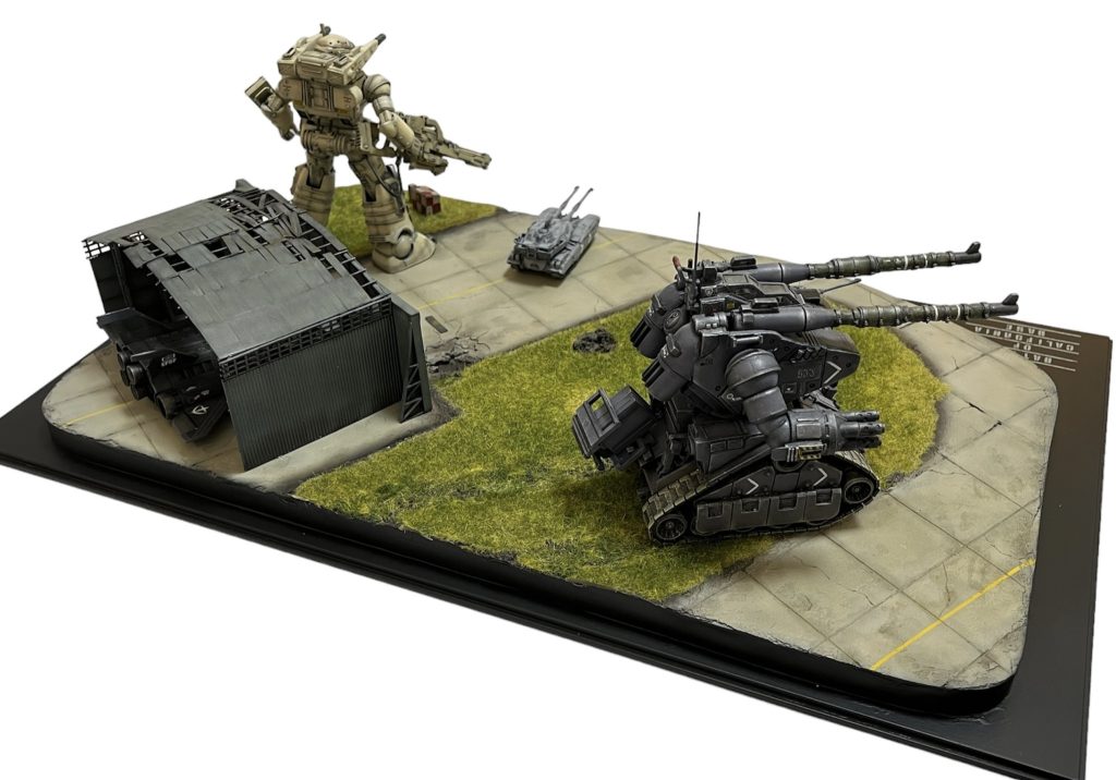 ジオラマ全景です。 小さいので画面を横にすると見えやすいかと。■台座サイズ : 300×500(プラスチック製)■ジオラマベース素材 : 発砲スチロール10㎜厚 +スチレンボード3㎜■地面素材: 壁補修材+Nゲージ用砂パウダー +木工ボンド■路面素材: 重曹+木工ボンド■格納庫 : Nゲージ用架線キット+プラスチック角材■ガンプラ使用キット: HGエコプラ/ガンタンク : HGエコプラ/ガンキャノン : 重力戦線シリーズ/61式戦車 /連邦兵士フィギュア : 旧キット/コアブースター 以下、製作にあたっての拘りになります。