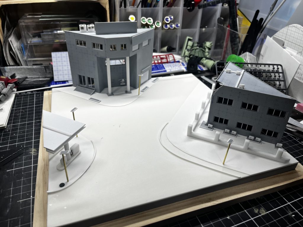 ジオラマの製作ですが、今回は郡山の展示会や12月に行われるオフ会に向けてちょっと本格的に市街地ジオラマに挑戦しようと思い、プラ素材からフルスクラッチしました。今までも市街地は何度もやっていますが、全体の構図にこだわるのみで、建物に力を入れていなかったので今回は建物を作ることに力を注ぎました。窓枠を多層構造にしてサッシをイメージしたり、エアコンの室外機を実寸から計算してちまちまと作ったりがんばりました。