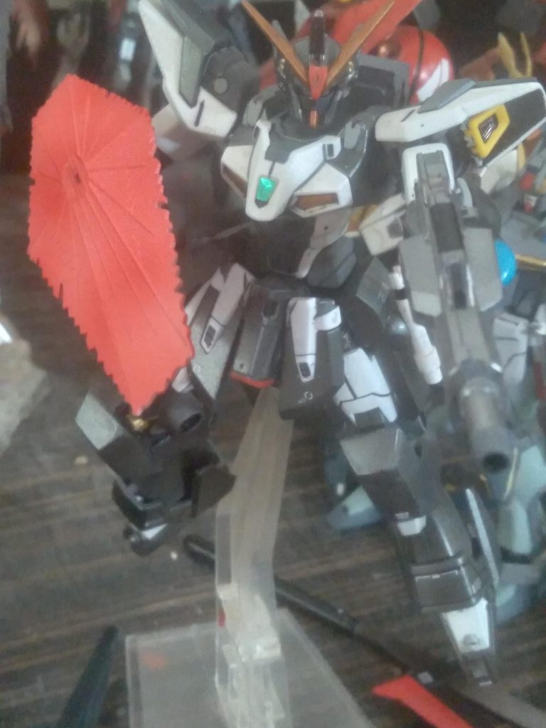 For weaponry, it uses a GN beam rifle from the astrea, cosmic era beam sabers and beam shield. The knees were scratch built using pla plate, putty, and ibo parts. Finished them off by adding thrusters