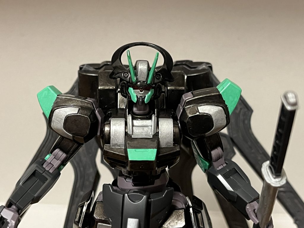 性能オリジナルのDG細胞が使用されている関係上、極めて高い性能を誇るが、パイロットへの負担も凄まじく、並の人間であれば脳死する危険性を誇るが、高い適合率と強靭な精神力があれば、感染のリスク無しでの使用も可能となる。アンリミテッドエンジン胸部に搭載された動力源の永久機関。ただでさえ核エンジンに匹敵する膨大なエネルギー生産量を誇る上、オリジナルのDG細胞による強化によって、大幅に高出力化されている。デッドリージェネレーターパイロットの怒り・悲しみ・憎しみなどと言った負の感情に比例して戦闘能力を強化するシステム。パイロット自身が黒歴史を経験してきた為、本来であれば何もせずとも高い適合率を有していたが、パイロットの家族が殺害された事で、その心が壊れて負の感情が爆発し、ただでさえ高い適合率が飛躍的に高まった結果、95%というほぼ完全適合に近い状態で覚醒している。防御力・耐久性DG細胞を用いた全身を覆う漆黒の装甲「ブラックジェネラルアーマー」が備わっており、あらゆる衝撃を吸収して戦闘継続性を高める徹底的なまでの重装甲化によって、ビームサーベルや陽電子砲の直撃さえも、防御姿勢を取る必要すらなく防ぎ切るほどの鉄壁の防御力を秘めている。頭部の各種機能情報収集力の強化が施されているだけでなく、10km先の枯れ葉の落下音をも聴き分ける非常に敏感な聴覚を与える為、間合いの敵を目視すること無く斬り捨てる事が可能。ツインアイにも、相手の構造的弱点を見極め瞬時に打ち込みに最適な部位を発見できる機能も追加されている。DG細胞をパイロットに一時的に浸透させる機能によって、パイロットの集中力を極限まで引き上げ、居合の一瞬を見極める事が可能。これによって反応速度も極限まで高められている他、この機能に対する安全対策として、精神安定剤を常時投与し続ける機能とハッチ解放時に脳や全身のDG細胞と安定剤を分解する機能も備わっており、パイロットの精神を常に鎮静化して判断力低下を防ぎつつ、本機から降りればすぐにリフレッシュできる。ただし、負の感情が強過ぎたり、頭に血が上った場合、これらの機能を以ってしても冷静さを失う可能性はあり、精神を完全に鎮静化させる訳では無い。攻撃能力パワー面にも優れており、武器無しの殴り合いでも通常装甲はおろかPS装甲すらも、パンチやキック等の通常攻撃の一撃のみで撃破可能とするほど。両腕部には、剣技に必要なあらゆる動作を可能とし、後述する専用武器「武刃」を用いた戦闘に特化した調整が施されている。両脚部には、下半身の重量バランスをリアルタイムで調整して走力・キック力・ジャンプ力を向上させる機能も備わっており、敵との鍔迫り合いだろうと押し負けない理想的な体捌きを実現する。この機能によるジャンプ力もかなり高く、重力下でも推進力を用いずにハイジャンプが可能となっている。機動力・スピード本機のパワーと出力による恩恵によって、重装甲ながらも歩行速度と運動性は非常に高く、極限まで強化された反応速度も相まって、地上戦における機動力は損なわれず、本機による理想的な剣技にも一役買っている。宇宙空間でも運用可能で、重力下でも飛行可能な推進力自体は備わっているが、推進力を用いた機動力そのものは遅く、加速手段がガーディアン・マントのみに限られる為、本機で空中戦や宇宙戦を行うには、ジャンプ後に推進力とガーディアン・マントで敵の高低差を上手く調整する必要がある。そもそも地上戦における近接戦特化型の重装甲MSの本機は、特別的に機動力には特化している訳でもない為、この仕様はむしろ「最低限の空中戦と宇宙戦に対応できるだけの汎用性が備わっている」と解釈できる。だが、頭部の各種機能とガーディアン・マント、そして極限まで高まった反応速度は、地上戦での絶大なアドバンテージのみならず、空中戦・宇宙戦における機動力の低さを補って余りあるほどの効果を付与しており、ドラグーンシステムのオールレンジ全方位攻撃をも回避できるだけでなく、最高速度のストライクフリーダムガンダムの動きをも完璧に見切り、亜光速レベルで動くMSにも対応できるほど。ワープ機能黒い霧を放射しながら、本機をワープさせる。半径10kmまで移動可能だが、エネルギー消費量は本機のアンリミテッドエンジンでも激しい。