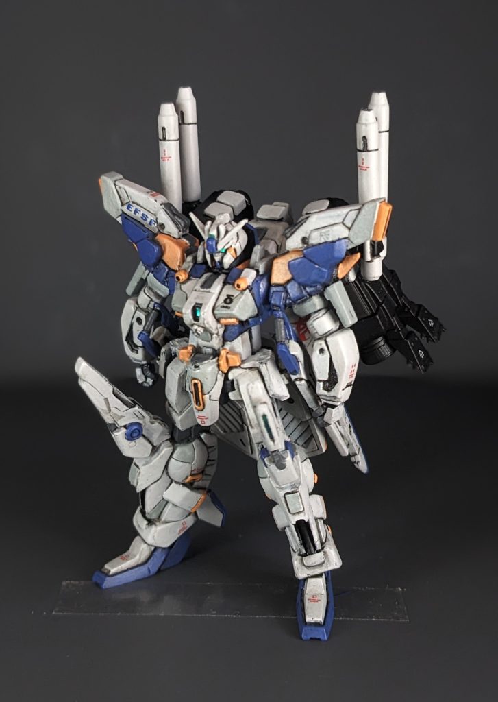 第3兵装。3つの兵装の中では攻撃力と推進力に優れる。ブースター・ユニットを2基装備しており、ノーマル形態に比べて全備重量は8割増しになる一方で総推力は11倍になる。そのためパイロットへの肉体的な負担はかなり高く強化人間でやっとまともに運用することができる。第2兵装のような小回りは効かないため拠点攻撃用の装備となっている。