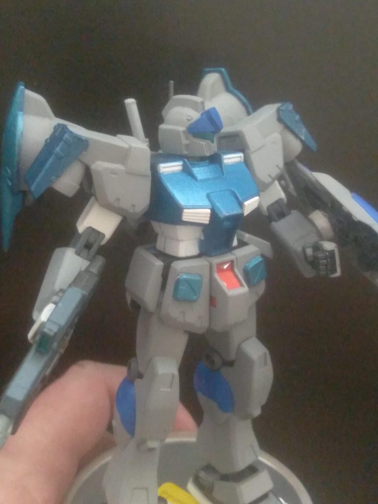 SETTING: Before the GP01FB was made, Anaheim Electronics needed to test out the additional equipment. An older GM Custom was chosen and refurbished to be able to equip the thrusters. The entire MS was overhauled. Thrusters were tuned to have more output, giving this MS incredible speed and maneuverability. The prototype backpack booster units are on movable arms for unmatched control.