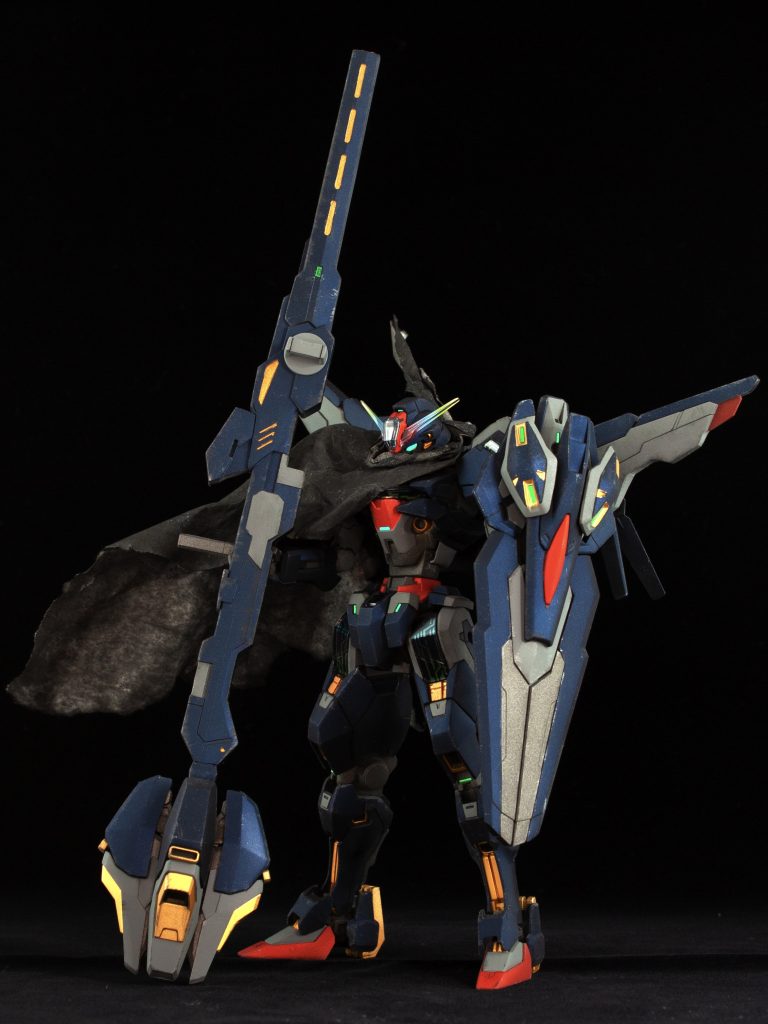 キャリバーンの改修型ということで武装を強化。特徴的な箒銃は前部を切断してカテドラルのライフルと合体してボリュームアップ。シールド中央のビット基部をカテドラルのシールドに移植。バックパックはキャリバーンを基部に取り付けられるようにしています。本体は、腰と二の腕、脚部を延長してプロポーション改修しました。