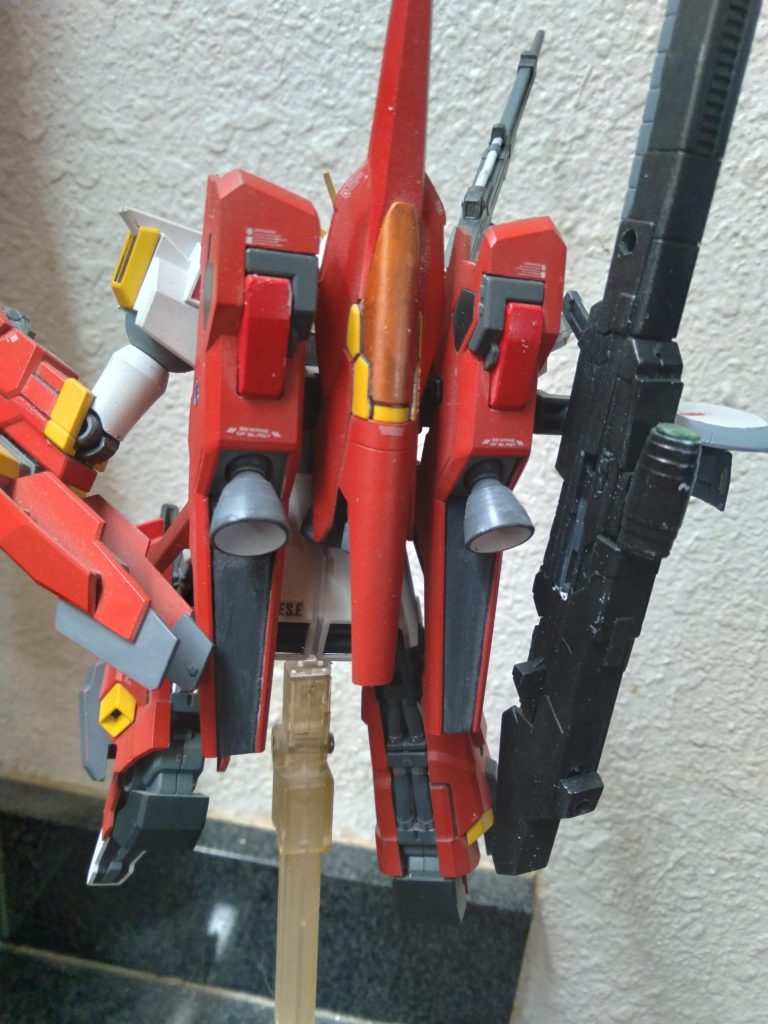 It shares the standard RGZ series weaponry. However it has added hard points on the legs and binders to allow for different equipment and weaponry to be installed. This setup is equipped with the newly redesigned hyper mega beam cannon. It's a powerful weapon that is capable of sinking battleships in a single shot. The weapon has a large sensor as well as a radome for improved targeting acquisition and precision firing. There are optional 3-tube missile pods that can be attached to the legs.