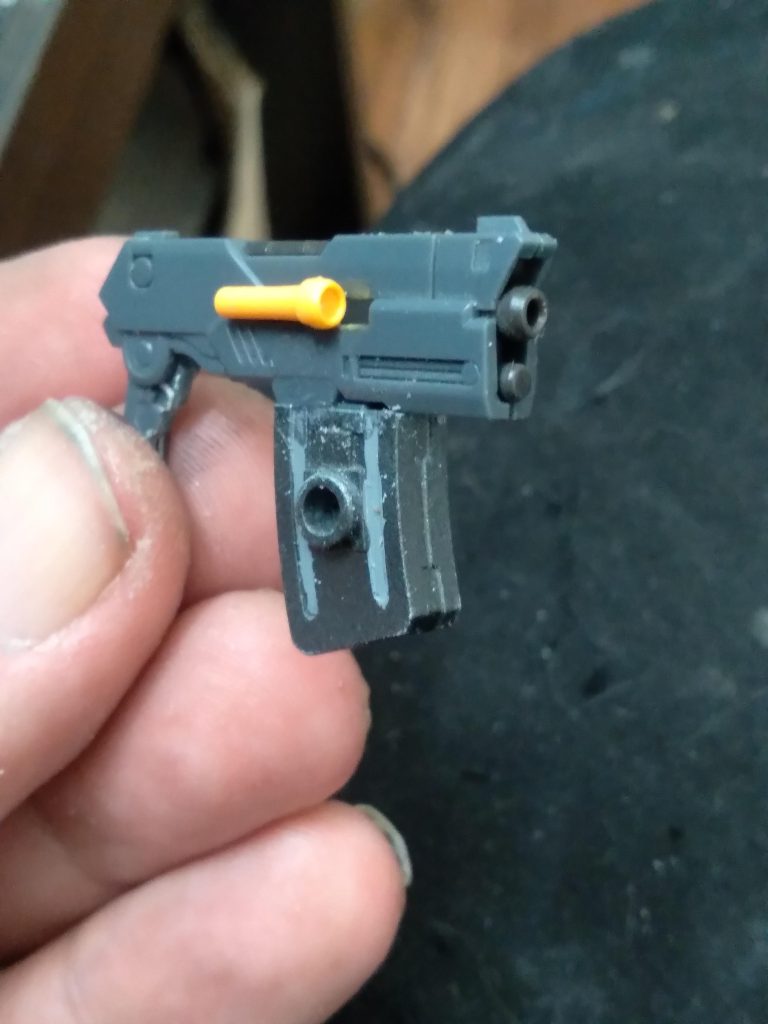 This will be it's primary ranged weapon. It was given to me by a friend so I don't know exactly what kit it is from. I modified it slightly so that it can fit in the HG hands. I also added a magazine from the 30MM series. I am calling it the Buster Magnum. 