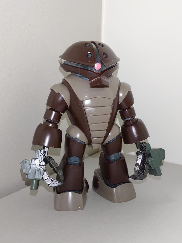 【概要】MSM-04F / アッガイ(ダブルナックル仕様)Afterglowのドラムス担当・宇田川 巴が、ガンプラバトルのために制作したガンプラ。設定上は「宇宙でも使用できる」ということになっているため、当初は「リックアッガイ」と命名する予定でいたが、参戦直前に氷川日菜に一喝され、単にダブルナックル仕様のアッガイという体裁に落ち着いた。105mmバルカン砲×4門、4連装ビームガン×2門を装備し、ビームガンは着脱可能。他に大型剣を使う。