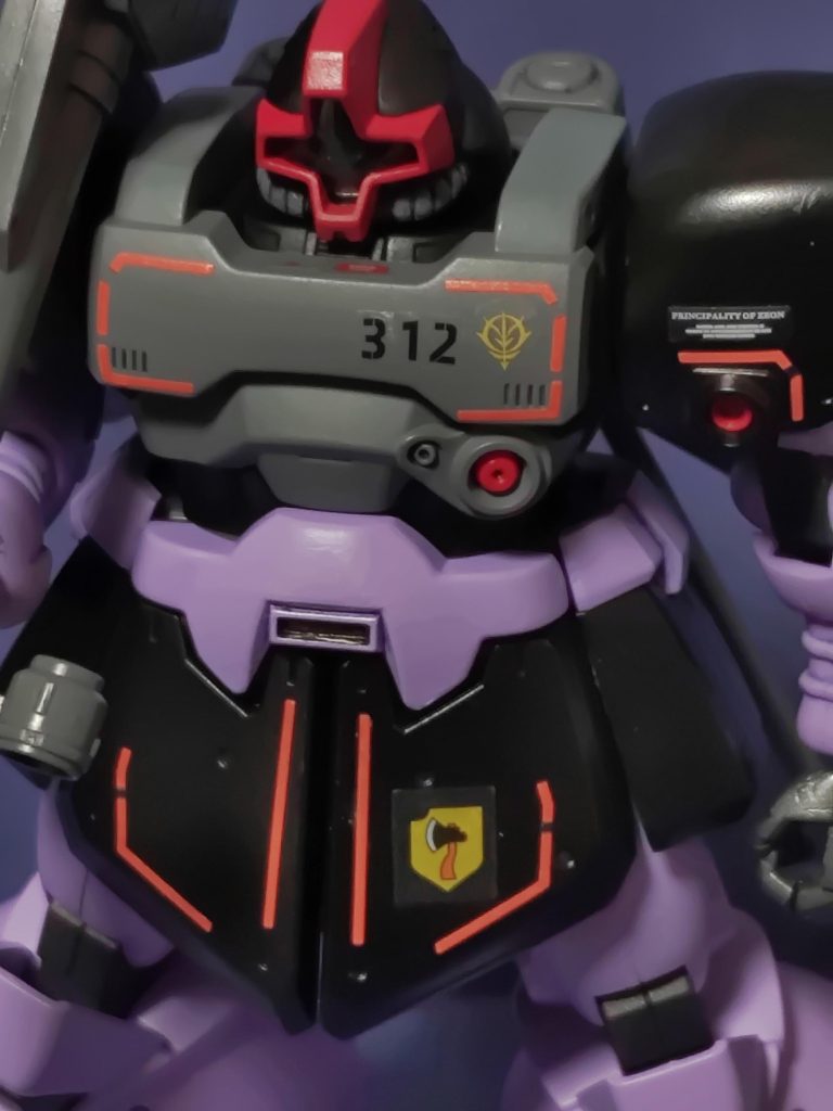 ここからはエンブレムについて語ろう。「「獰猛なる雛菊」のドムに何故ヒナギクが描かれていないのか?」という疑問を持つ人もいるだろう実はそこに裏話があるのだ。これから紹介しよう左フロントアーマーに描かれているエンブレム名は「斧」である。上官ヨハン・ウィレム少佐のパーソナルマークがそのまま部隊エンブレムとなった。故にカイパーのドムにも斧が描かれているのだ余談であるが、ウィレム自身もMSでの斬撃戦を得意としていた