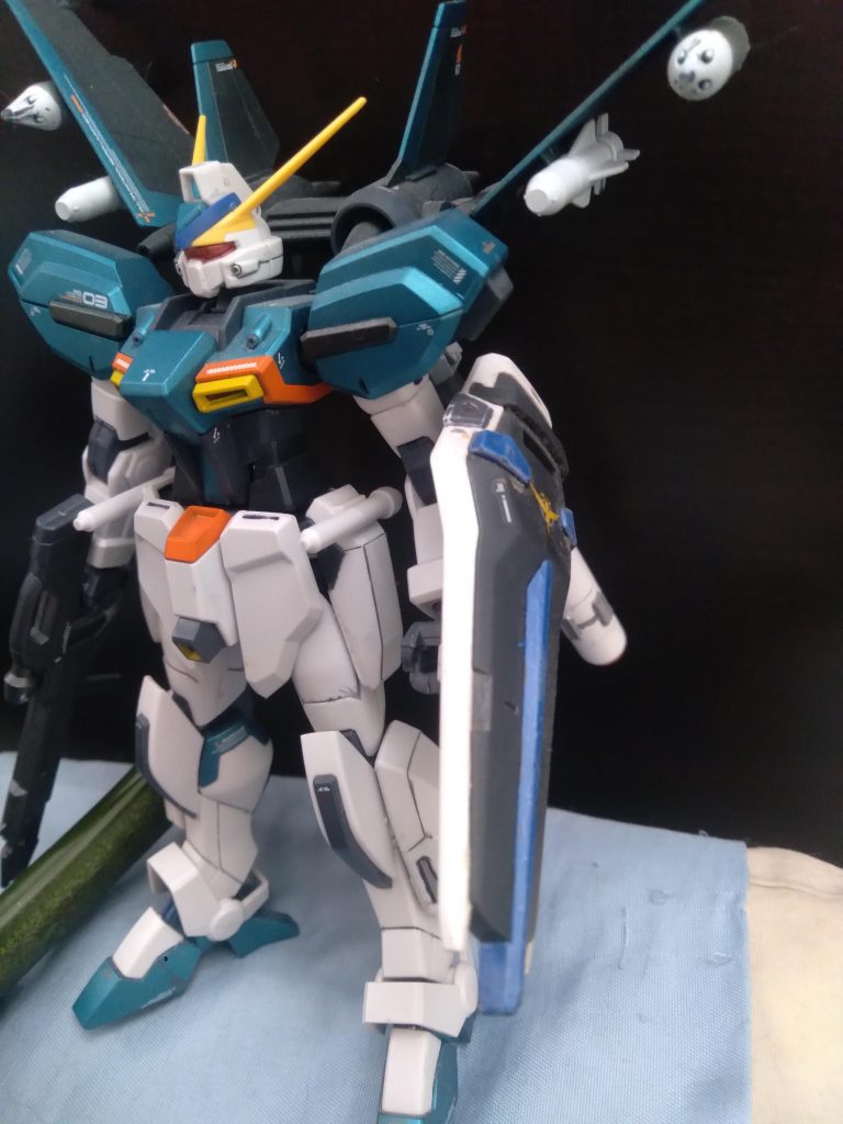 Here is the GAT-04 Windam with its Jet Striker Pack equipped. This unit carries the Strike shield and has 2 propellant tanks installed to give it more flight time. The wings are loaded with large Air-to-Surface missiles as well as 2 multi launch rocket system pods. The beam rifle is a newly developed 75mm high output rifle 