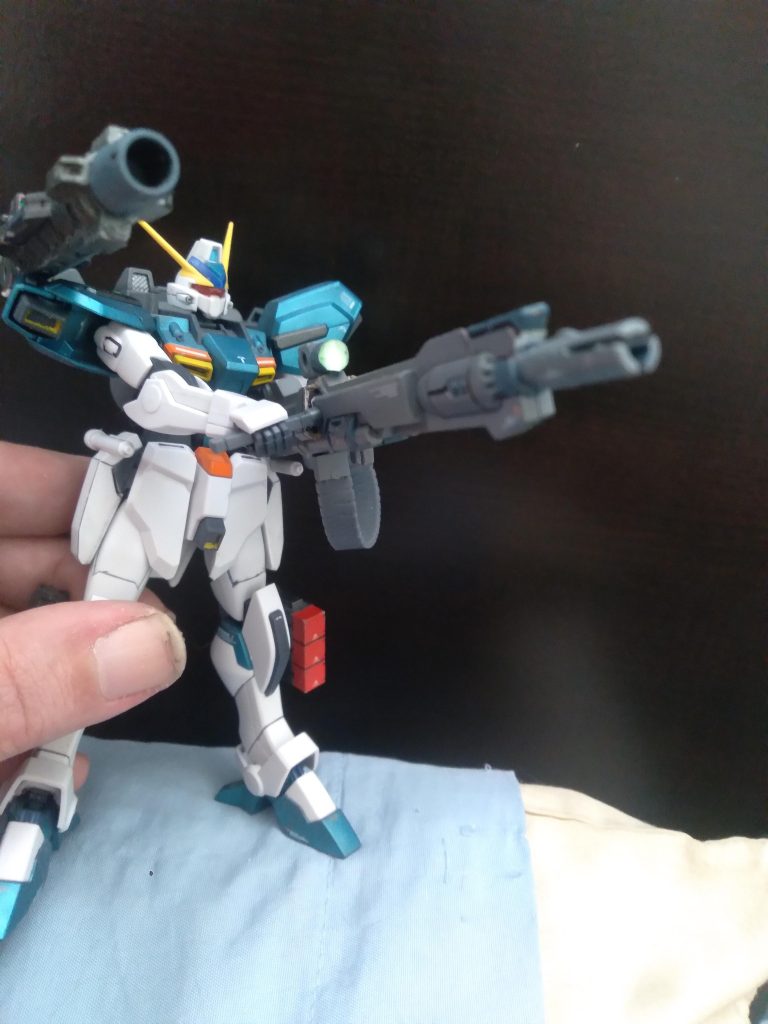 This particular unit is equipped with the experimental test unit for the Launcher System MkII. It has a more powerful Agni hyper Impulse cannon, a new 250mm high output beam cannon, and has two 3-tube missile pods on the legs. These pods can also be mounted to the high output beam cannon so the leg thrusters can be equipped 