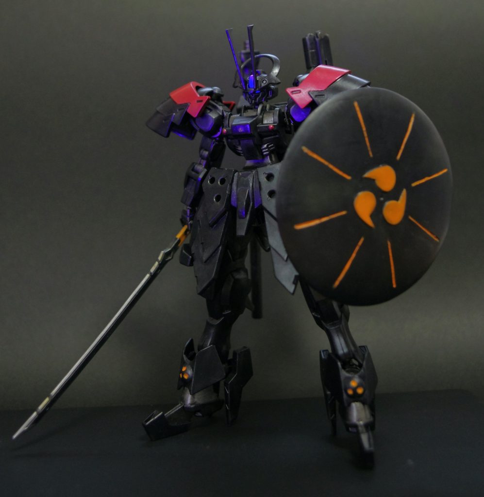 3代目黒騎士・デコーズ ワイズメル(凸助)搭乗のバッシュがモチーフです。「ハンマーのようにして敵機を食らう」シールドは100均のプラ皿から作りました。太刀はバルバトスのものを拝借。また、頭の「ツノ」を伸ばすことによって、バッシュ感が増幅します。