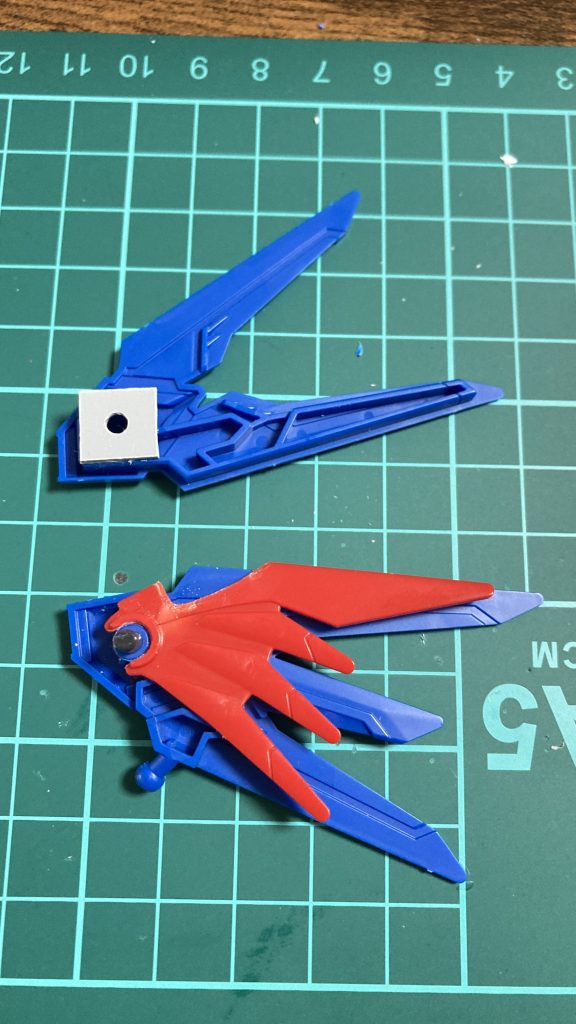 翼の制作工程です。ライジングフリーダムの翼の受けにデスティニーの翼を一部カットしたものをはめ込みました。このままではライフリの翼が付かないので適当な3mm棒を通して反対側にプラ板+3mm穴を設置。干渉する部分はリューターで削っています。