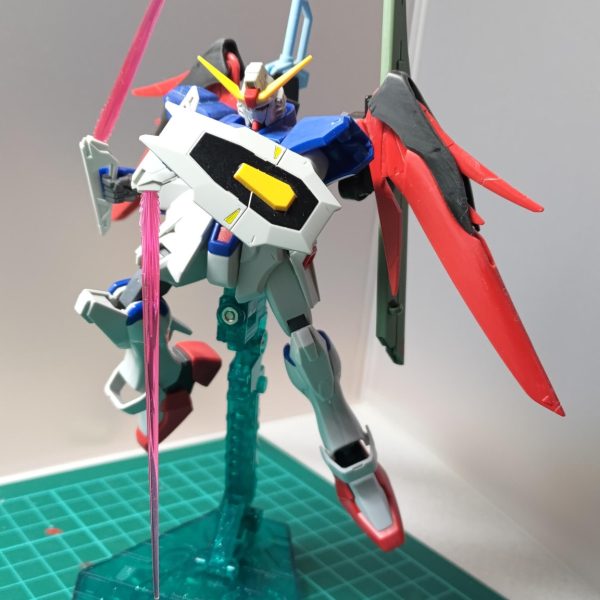 旧HGディスティニーガンダム制作中です。ライジングやイモータルが投稿されるご時世に・・・合わせ目処理、モールド彫りなおしときて、全身のヤスリ掛けをしております。600番でヤスリ終わったところでテンション上げるためにポージングをいくつか決めてみました。写真１(メイン)：購入時に目を引かれたオレンジ色のエフェクト。これに合わせて機体を塗装したいところです。加工しながらどんな色にしようかイメージしてます。写真２・３：欠品であったフラッシュエッジのエフェクトの代わりに、RGアストレイレッドのビームサーベルエフェクトを付けられるようにしました。柄が特徴的なビームサーベルという扱いですね。今回は普通に持たせますｗ写真４：パルマフィオキーナの手首パーツで、ドラゴンボールでありそうな強者っぽいポーズ。見えづらいけど、アロンダイトと長距離ビーム砲のアームにパーツを追加して、光の翼の前後の可動範囲を広げてます。写真５：脚部の合わせ目処理をした写真です。膝のパーツを切り離して接着し、スネや脹脛は段落ちモールド化しました。また、内部のボス/ボス穴を切除しまして、脹脛のスラスターの可動範囲を広げてみました。回し蹴りとかする時に有用そうかな、とｗ（3枚目）