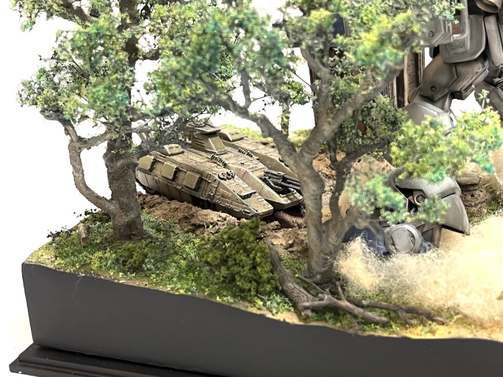 フラワーワイヤーを数本まとめて捩り、骨組みを作った後、木工ボンドで肉付けしパウダーをまぶしてテクスチャー表現した自作の立木。葉っぱはKATOの「木の葉」を使用。