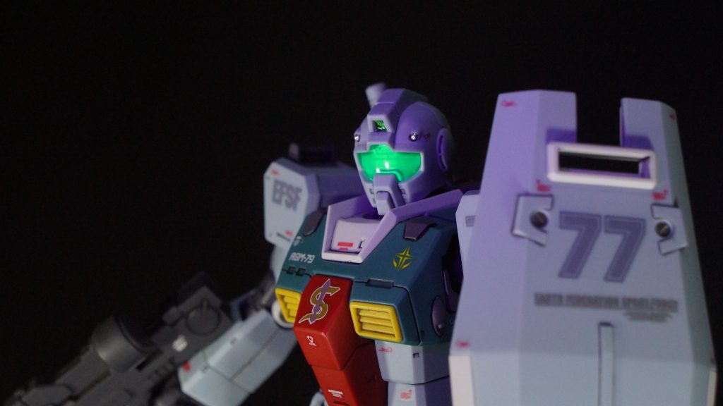 バイザーは裏側に蛍光グリーンをクリアーで薄めた塗料を塗っているので、ブラックライトで光ります。とさか部のカメラは設定ではオレンジ色のようでしたが、緑に変えています。いつものようにメタリックテープ+UVレジンです。