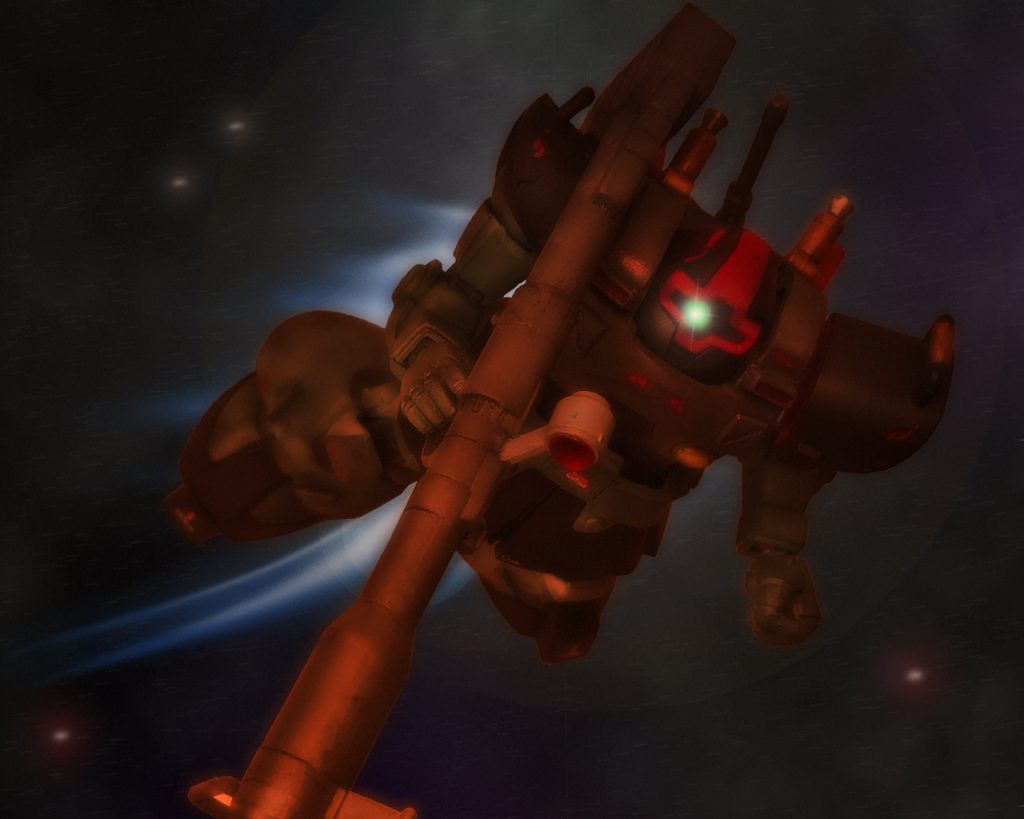 するとミサイルはトライバル隊近くまで来ると突然爆発した。ミサイルはやはり対艦用で威力は大きく、回避したとはいえリック・ドムは衝撃波で煽られる。だがキリュウの指示でリック・ドムは作戦に支障をきたす損傷はなかった。「何だあのミサイルは?」「近接信管だっ！」近接信管は、砲弾が目標物に命中しなくとも一定の近傍範囲内に達すれば起爆できるものである。対艦用の大型の物であれば当たらずとも途中で起爆すれば広範囲を爆風に晒す事ができる。「各小隊慌てるな。対艦ミサイルがそうそう当たるとは敵も考えていない。あくまで基地に接近するのを遅らせるのが目的だ。敵が本格的に動くのはこれからだ」