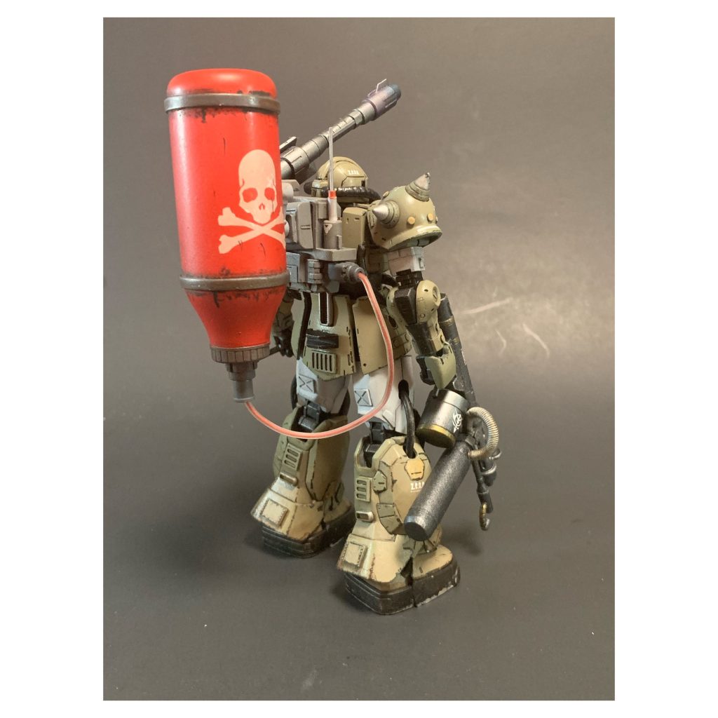 Extra armor and pieces put in with a combinations of builders parts and styrene pieces cut to fit. The cannon was moved from the right shoulder to the left and a fuel tank was added to the back. 