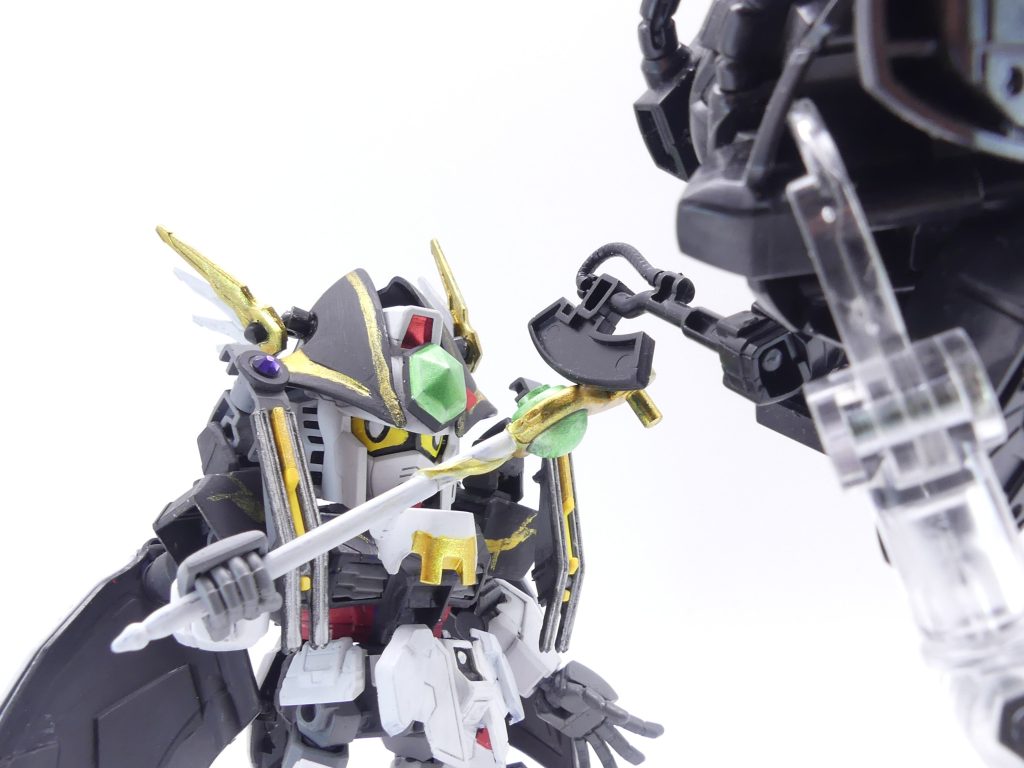 「ガンプラは、魔法だ!」。父はよく、そう言っていました。ガンプラの持つ魅力は、様々な面であらゆるものをつなげる力があると。その力を、今。アマミチが、纏うときなのです。再度ログインしたアマミチ・・・いや、ガングリモワールは、ガンニッパーに少し驚かれながらも、周辺の「ミスク」・・・黒い影のような敵対生物・・・の掃討にかかることになりました。「相手がミスクなら、ガンプラじゃないんだ・・・僕だって!」ガングリモワールは、「ガンプラ魔法」の使い手です。「プランガ、ナンラー、ローズーヒ!!」召喚したのは、組み立て体験会ガンダムの腕のようなパーツ。それが勝手にビームライフルを放ち、ミスクを倒していきます。もう一つのビームサーベルは、迫ってくるミスクの攻撃を受け止め、切り裂きます。ガングリモワールは、無事にガンニッパーとミッションを達成したのでした。「やっぱり・・・封印が、破れてる・・・!」「エバーブック」を通して、マサミチの声が聞こえてきます。アマミチがログインした場所は、かつてエバーランドと現実世界とをつなぐパワースポット・・・「扉」があった場所の近くでした。かつてマサミチ達が行った封印は破れ、それを象徴する三つの玉は何者かに持ち去られていたのです・・・(次回は初夏~夏頃更新。次回を待て!)