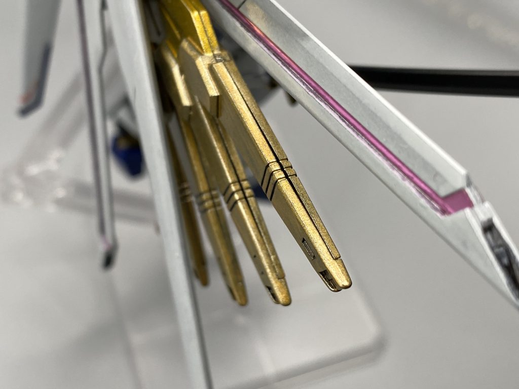 パーツカットはアルティメットニッパータフを交えた2度切りで、いくらか気になった部分はヒケ処理もやっています。もちろん、アンテナはシャープ化。その後、洗浄→乾燥。このキットは合わせ目が段落ちモールドになっていたり、別パーツで隠されていたりと随分配慮されていますが、プラウドディフェンダーの金色部分(ドラグーン)では合わせ目がくっきりでます。ここを合わせ目消ししておけばよかったです。