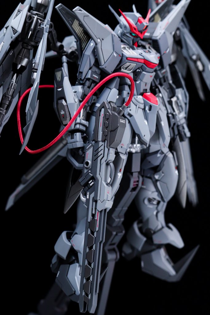 武装にはSDのサージェントヴェルデバスターの肩部分装備とMGストライクのビームライフルからグリップをミキシングし、バックパックからケーブル接続で電力供給をおこなうレールガンのようにしました。ケーブル接続部分はコアガンダムのジャンクパーツとプラ板、プラ棒でのスクラッチです。写真を撮り忘れたので穴が空いているようにしか見えないのですが、ケーブル接続の位置を後方から右側に変更できるギミックも制作しています。