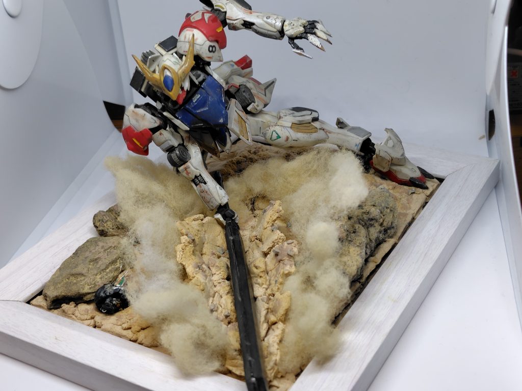 斜め上から叩きつけた部分の地面が割れるようなイメージで紙粘土を付けました。