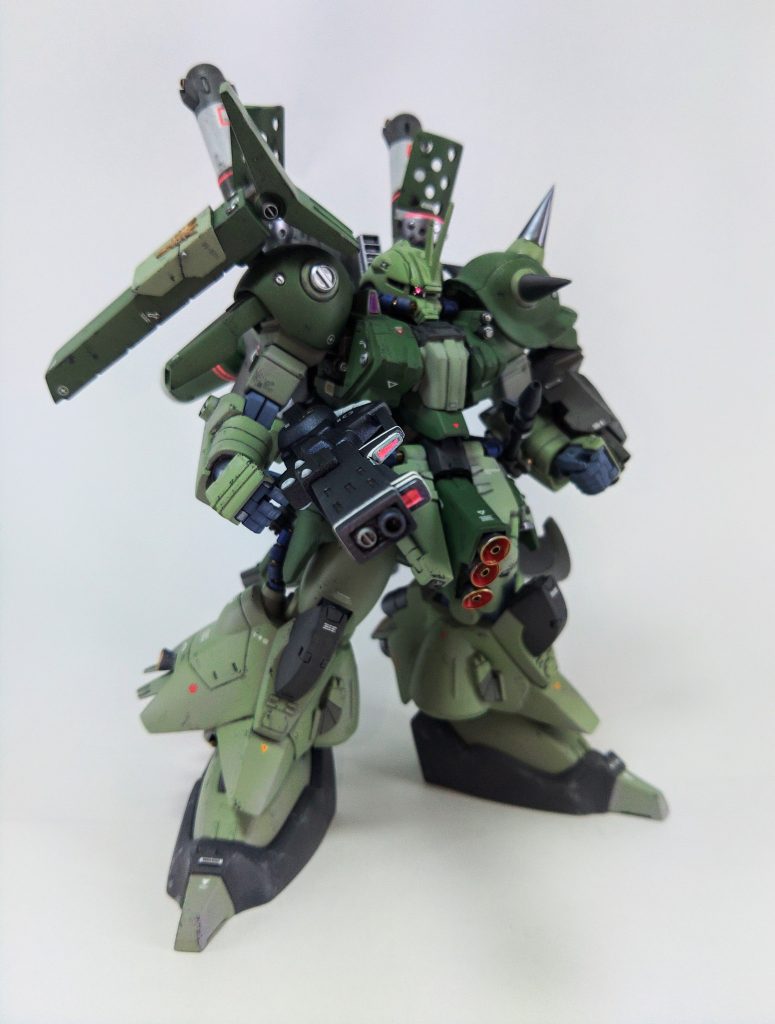 本体の改造はキットのパーツを極力活かす方向で、関節位置の調整と各部の延長工作がメインです。ドーベンウルフの首を軽く捻れるくらいのマッシブな体型にしています。細部にMS-06Rの記号を採り入れつつ、サザビーやジオのように片腕で安定してビームライフを連射できる重モビルスーツのイメージで製作しました。