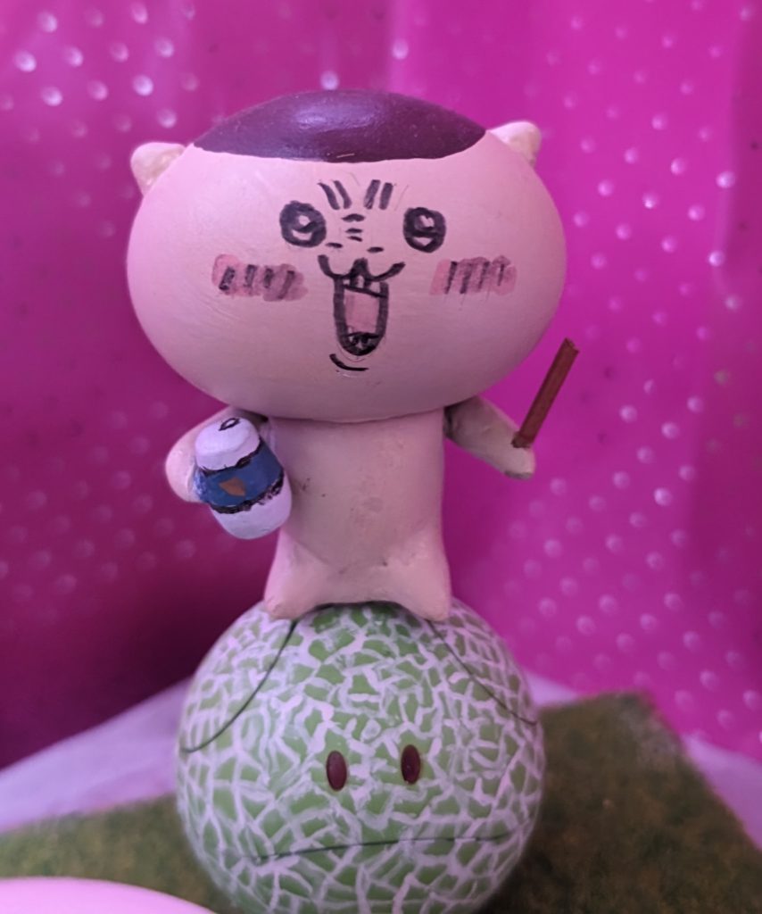 くりまんじゅうはチューハイとツマミを持たせておなじみの「ハァーーッ!!」って、表情にしております。チューハイの缶はプチッガイの腕をベースに、ツマミはプラ棒がら作ってます。くりまんじゅうが座っているメロンハロは極細筆で模様を手描きで描いています。