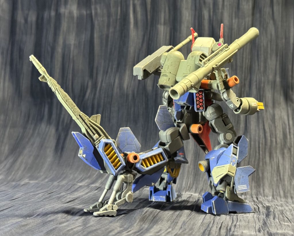 ガンドンスサイド7にてスーパーナパーム弾で燃やされたパーツの残骸から、調査団の手により再構成されたV作戦の名残。関係無いパーツなども混じってる可能性が有り、果たしてこれで合っているのか確信が持てなかった調査団だったが、その後サイド6で生存が確認されたテムレイ氏に「うん、これであってる。」とお墨付きを頂戴する。しかし調査団も半信半疑の中、ジャブローにデータを持ち帰る途中でジオンの攻撃に出会い本機体は海中へ落下、そのまま行方不明となった。