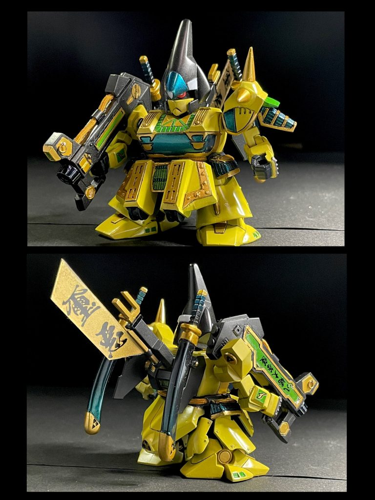 正面と斜め後ろ。BB戦士武者璽悪の以下の箇所を加工（順不同）脛をスクラッチで増設し等身アップ、接続をボールデンのボールジョイントに足、肩、前腕、サイドアーマー等の合わせ目にプラ板を挟んで幅増し胴体と一体だった顎を分離し可動化胴体を胸と腰の間で切り離し、可動化フロントアーマーの中央部以外をスクラッチして大型化&可動化、隠し腕を実装。隠し腕に持たせる武器も作成肘関節をパワードパワーダーの軸関節パーツを用いて可動化。肩との付け根はボールデン前腕を手首で2mm延長ハンドパーツを創傑伝・ヒーローズ系に交換。キットのメッキパーツ平手（闇の手）はSストライクフリーダムドラゴンの平手をベースに作成したものに置き換え肩と胴体の接続をSDCSフレームの肩フレーム4mmボールに置き換え股関節をSDCSフレームベースに置き換えて幅増しサイドアーマー可動化リアアーマー大型化モノアイ可動用のレバーを削除し、モノアイスリット幅を狭め、目つきを鋭く。モノアイを別パーツ化刀と鞘(2セット)をスクラッチ肩の後ろについていた放熱フィン(?)をバックパックに移設。刀の鞘をフィンに取り付けられるようにバックパックをプラ板で1mm厚み増し。「璽悪」の旗竿をプラ板等で作り直して大型化両肩の装飾パーツを分離して整形と塗装をしやすく。トゲは真鍮線を入れてシャープ化地獄邪悪砲（ヘルジャーク砲）を1cm延長。肩との接続を磁石に変更。持ち手を可動化。グリップエンドを追加。輪っかモールドを丸環に置き換え。ディテールをプラシート等で一部作り直し。パイプをハイキューパーツのメッシュパイプに置換。腰にもメッシュパイプ追加北条綱成モチーフとして北条三鱗を右肩と鞘に、地黄八幡の旗指物二種を作成小田原市PRキャラクターとしてデザインされた北条綱成を参考に円形の前立てを作成。磁石で取り外し可能。けど、ジオっぽさが減ってしまうのでボツにほか