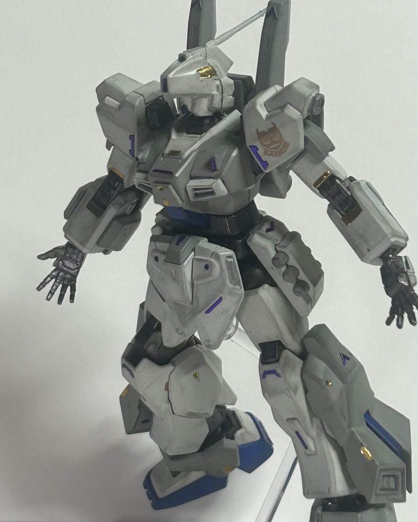 カラーリングとしてはメインにインシグニアホワイト。第二に明灰白色。青い部分にはブリリアントブルー。関節、バーニア等にメタリックグレイ。それをブシュっとした後にデカール、いつもの如くウェザリングマスターで汚して艶消し。仕上げにゴールドのミラーシートと3Dメタリックシールをちょいちょい貼りました。愛機となるべく生まれたガンプラだから好きな色で塗るべきだ、とも思いましたがそれは自重しました。だってインターミディエイトブルー一色で塗りかねないかと危惧したのです。それよりも使ったことがない色、明灰白色を多く取り入れると言う制約を己に課しました。……結果として地味過ぎたかと少し反省。白と言う色はどんな色にも融和する……と言う事で誰にもマッチする機体てな感じで如何ざんしょ。