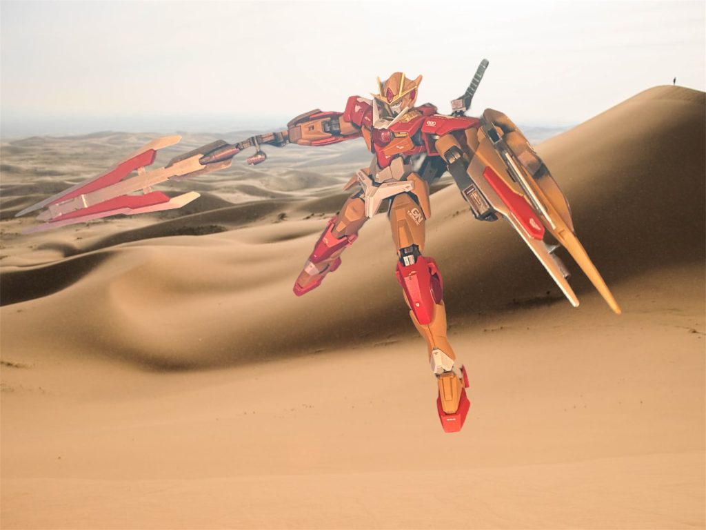 擬似GUドライブとはいえ、ツインドライブを搭載した機体の粒子放出量は凄まじい。右肩に装備された大剣プロトGNバスターライフルソードⅤを振り回して敵を薙ぎ払ってゆく。後のGNソードⅤに繋がる武装であり、重力下での運用を想定してGNソードビットとの合体機構は省略されており刀身も実体剣となっているが、その斬撃力は健在である。ライフルモード時には高出力ビームにより一気に多数の敵を攻撃できる。